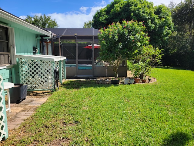 view of yard with a lanai and an outdoor pool