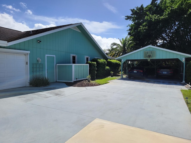 view of side of property featuring a garage and a carport