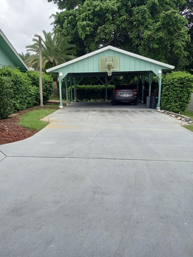 view of parking / parking lot featuring a carport and concrete driveway