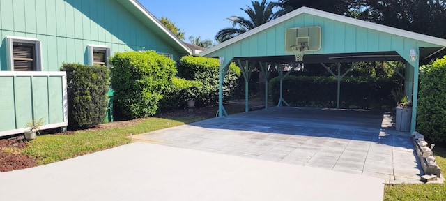 view of patio / terrace featuring a detached carport and concrete driveway