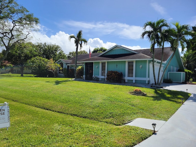 view of front of house with a front yard, a garage, and driveway