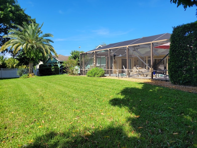 view of yard featuring a patio and glass enclosure