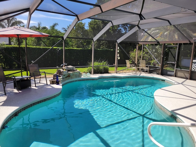 view of swimming pool with a lanai and a patio