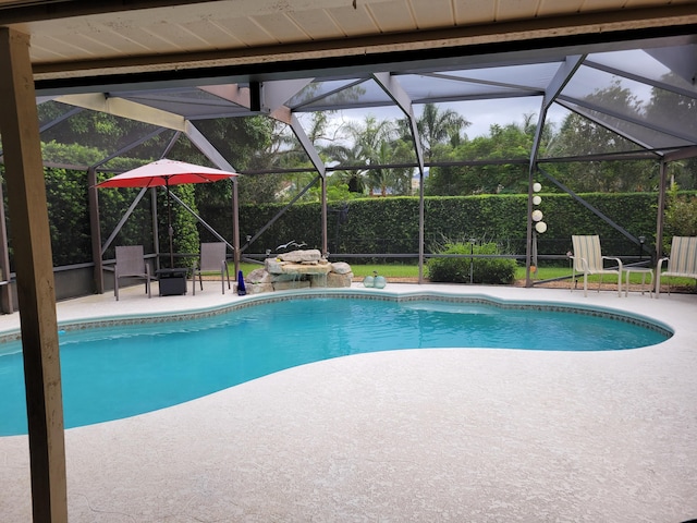 view of swimming pool with a lanai and a patio