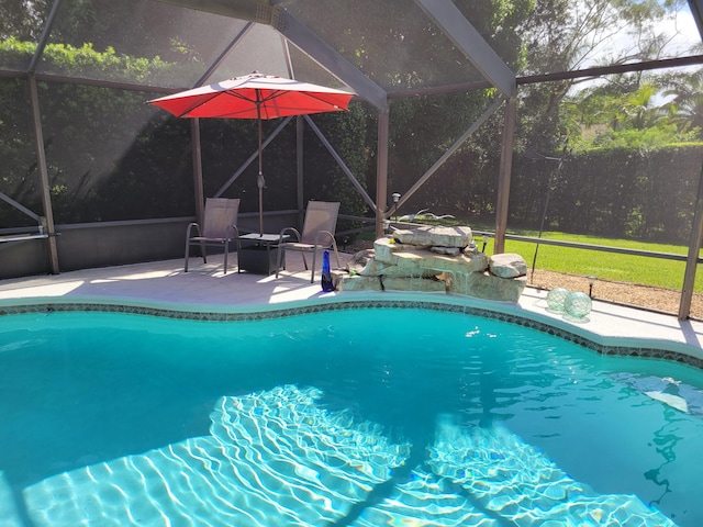 outdoor pool featuring a lanai and a patio area