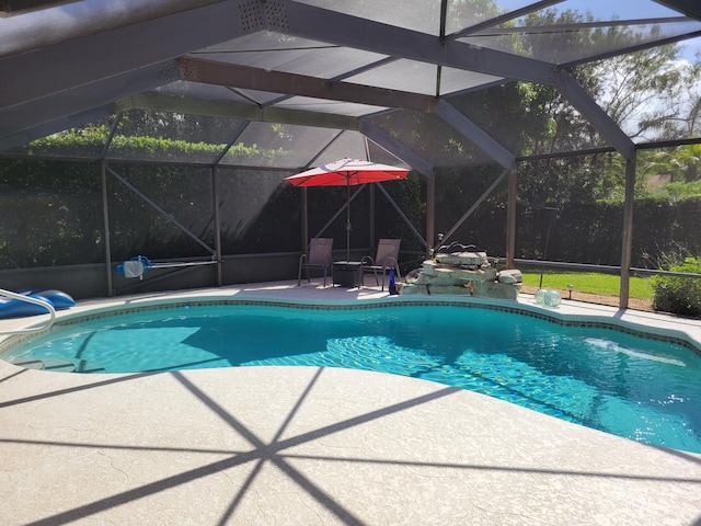 view of pool featuring glass enclosure and a patio area