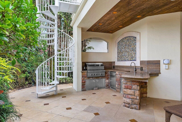 view of patio / terrace with exterior kitchen, sink, and area for grilling