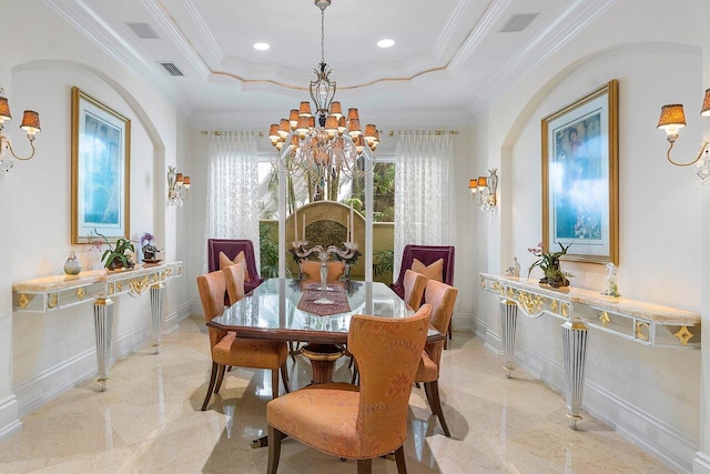 dining space featuring a tray ceiling, crown molding, and a notable chandelier