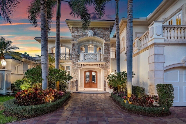 exterior entry at dusk with a balcony