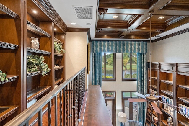 corridor with coffered ceiling, hardwood / wood-style floors, beam ceiling, and ornamental molding