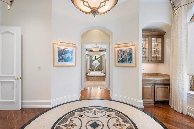 corridor with sink and dark hardwood / wood-style floors