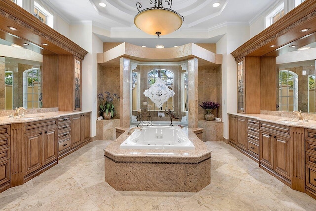 bathroom featuring a tray ceiling, a relaxing tiled tub, ornamental molding, and vanity