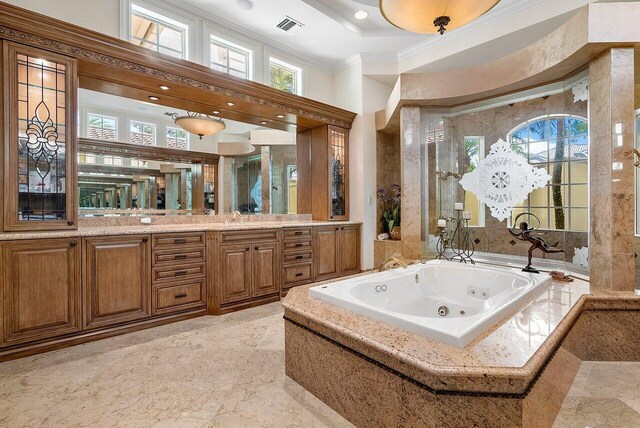 bathroom featuring a bath, a high ceiling, crown molding, and vanity