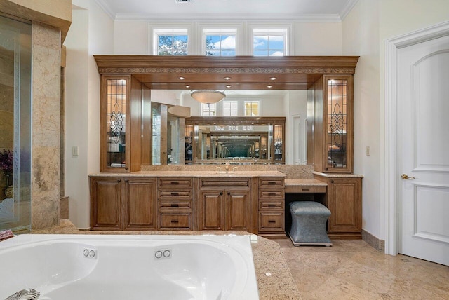 bathroom with a tub to relax in, vanity, and ornamental molding