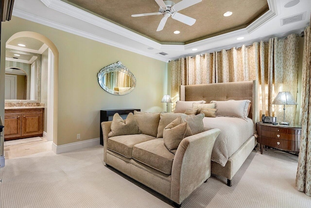 bedroom featuring ceiling fan, a raised ceiling, crown molding, and carpet floors