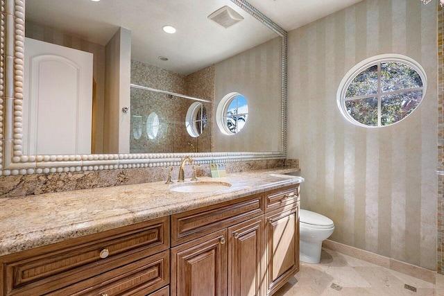 bathroom featuring vanity, toilet, a shower, and tile patterned floors