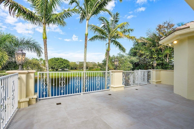 view of patio / terrace featuring a water view and a balcony