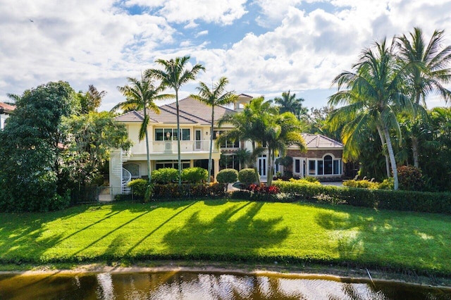 exterior space featuring a water view and a lawn