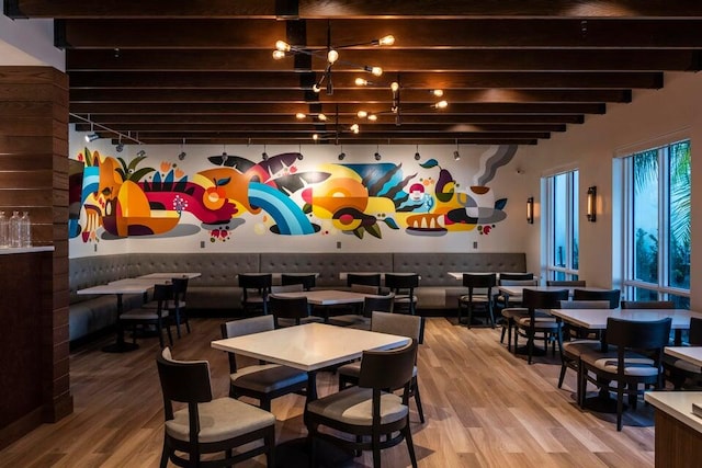 dining area featuring hardwood / wood-style floors and beam ceiling