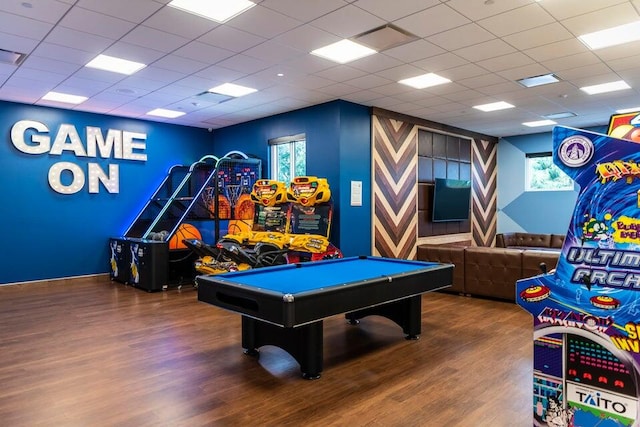 playroom featuring a paneled ceiling and hardwood / wood-style flooring