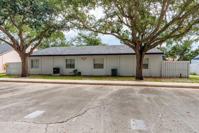 single story home featuring central AC unit