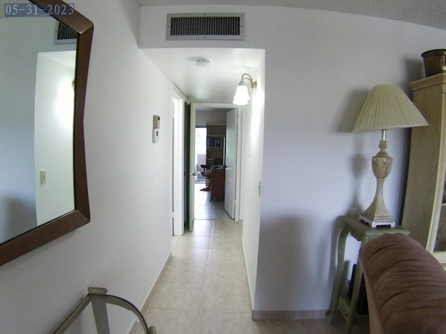 corridor featuring radiator and light tile patterned flooring