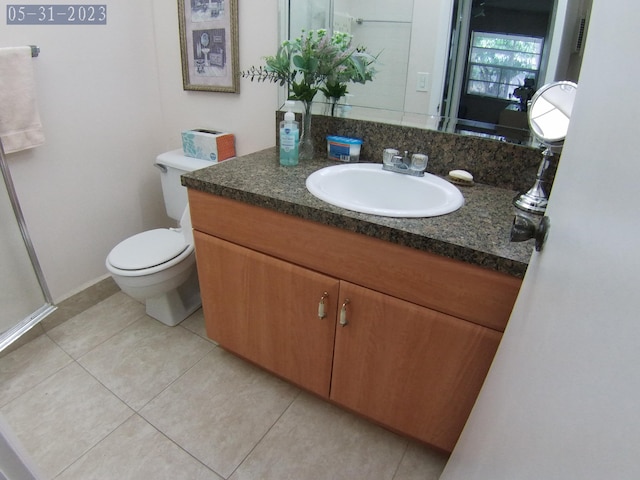 bathroom with vanity, tile patterned flooring, and toilet