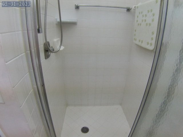 bathroom with a shower with door