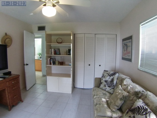 living room featuring ceiling fan and light tile patterned floors