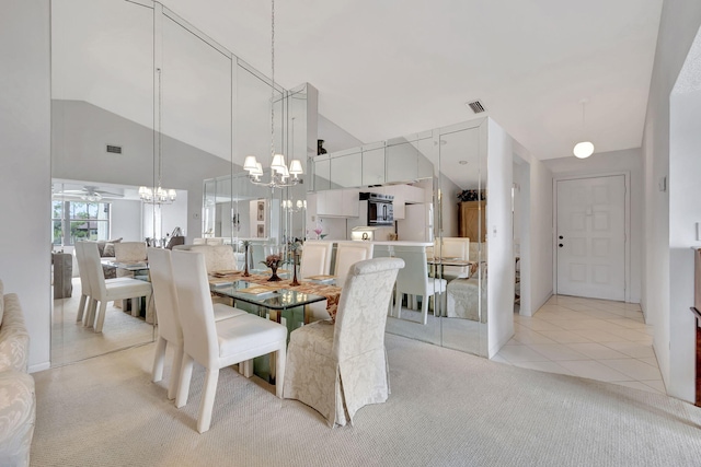 dining room featuring lofted ceiling, light tile patterned floors, and ceiling fan