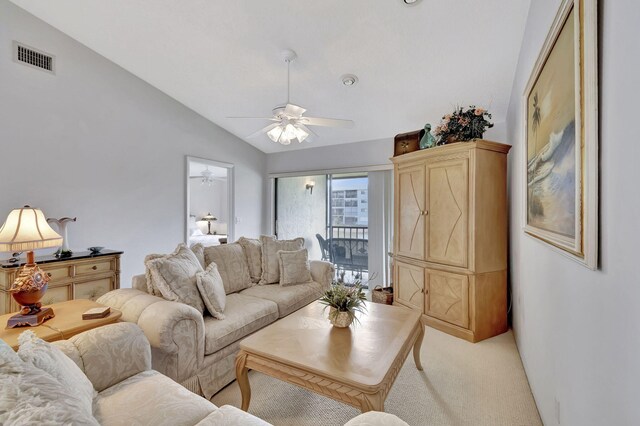 living room featuring ceiling fan, light colored carpet, and vaulted ceiling