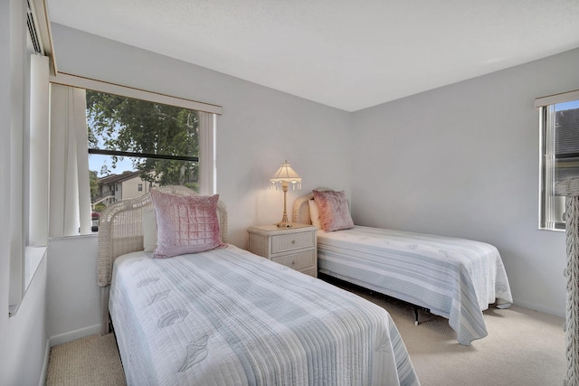 bedroom featuring baseboards and carpet floors