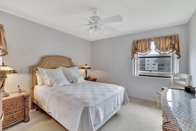 bedroom with carpet flooring, ceiling fan, a textured ceiling, and baseboards