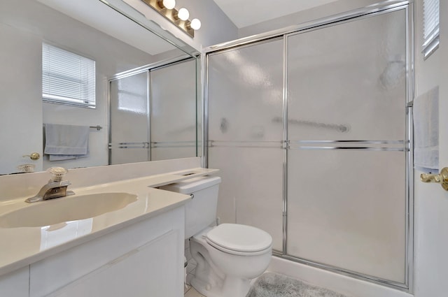 full bathroom with vanity, toilet, and a stall shower