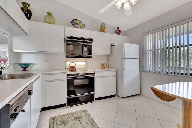 kitchen with light tile patterned flooring, white appliances, light countertops, and a sink