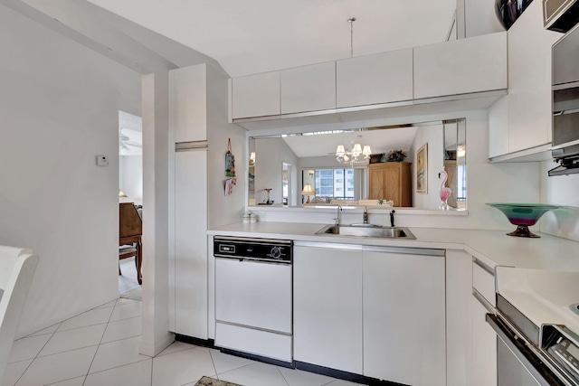 kitchen with sink, a chandelier, light tile patterned floors, white dishwasher, and white cabinets