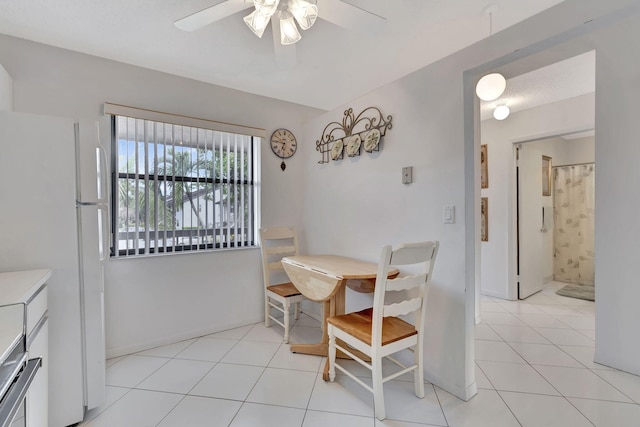 dining room with light tile patterned floors and ceiling fan