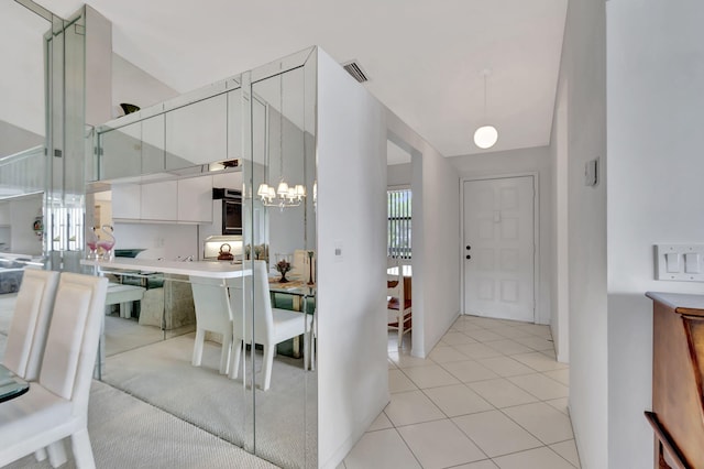 7618 Tahiti Ln Unit 201, Lake Worth, FL 33467 - entrance foyer featuring a chandelier, high vaulted ceiling, and light tile patterned flooring