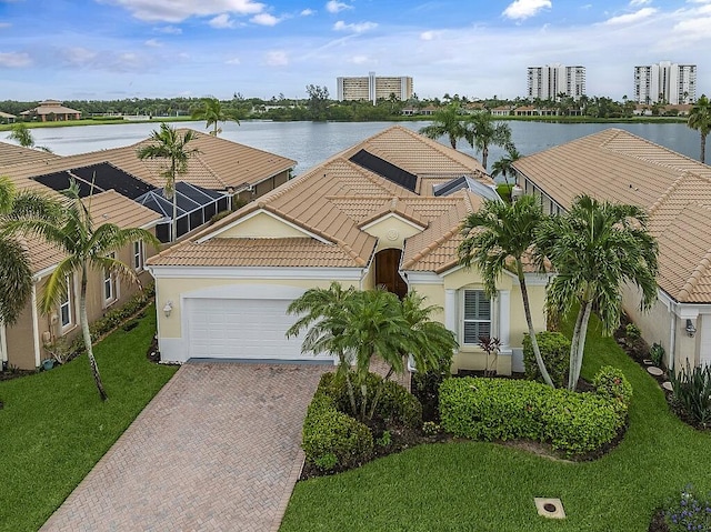 view of front of home with a water view, a front lawn, and a garage