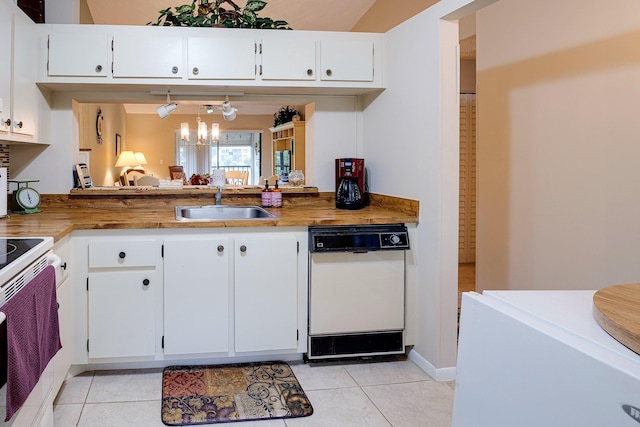 kitchen featuring white cabinets, white dishwasher, light tile patterned flooring, and range