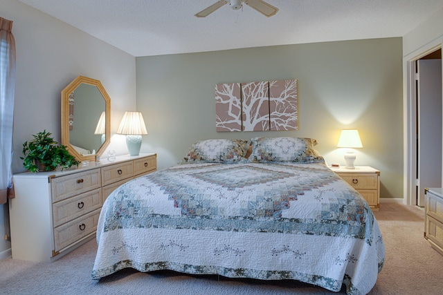 bedroom with ceiling fan and light carpet