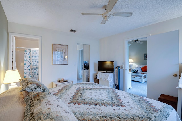 carpeted bedroom with a textured ceiling and ceiling fan