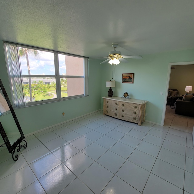 unfurnished bedroom featuring light tile patterned flooring and ceiling fan