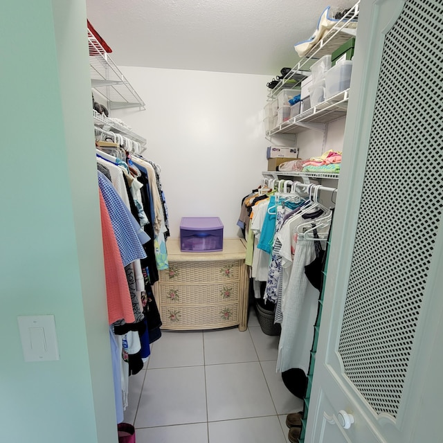 walk in closet featuring light tile patterned flooring