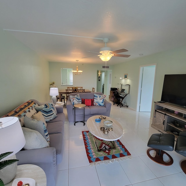 living room featuring light tile patterned floors and ceiling fan with notable chandelier