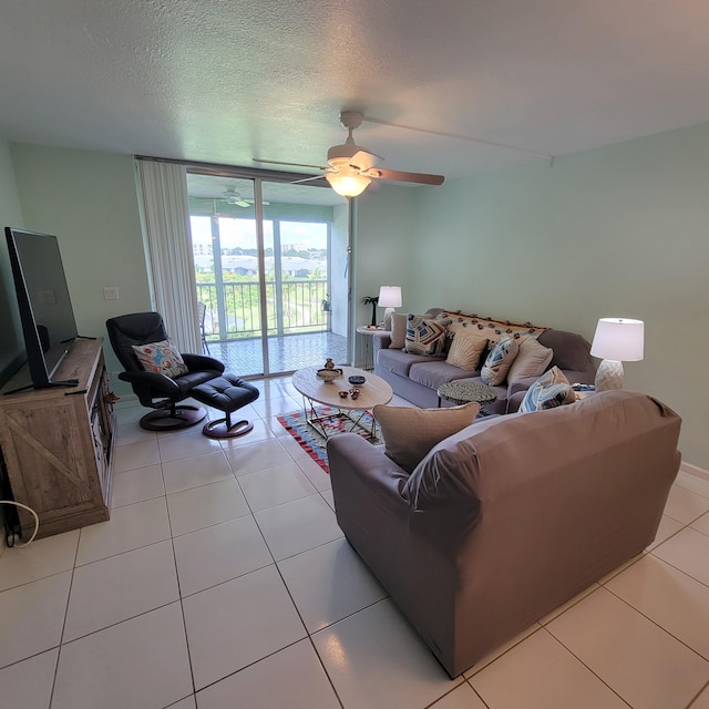 tiled living room featuring a textured ceiling and ceiling fan