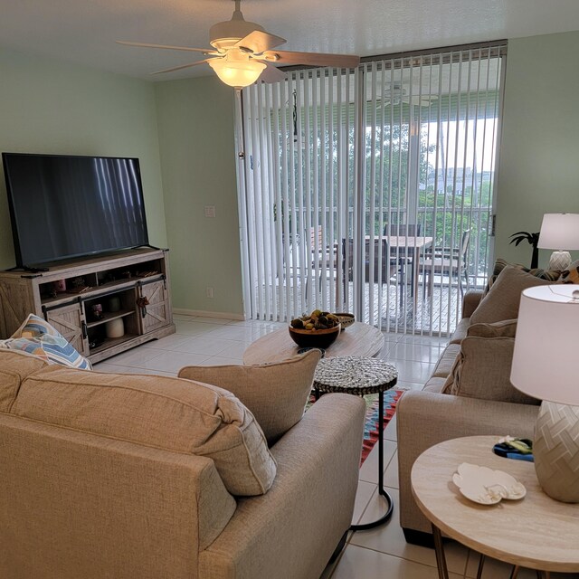 tiled living room featuring ceiling fan