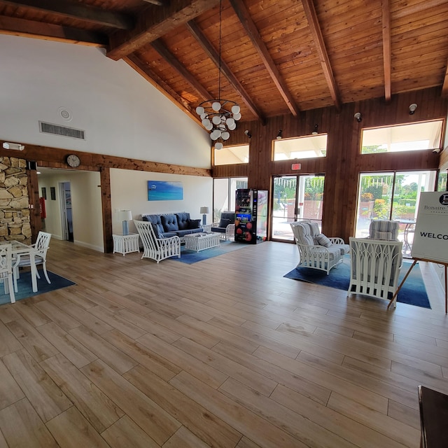 unfurnished living room with high vaulted ceiling, hardwood / wood-style flooring, wood ceiling, and beamed ceiling