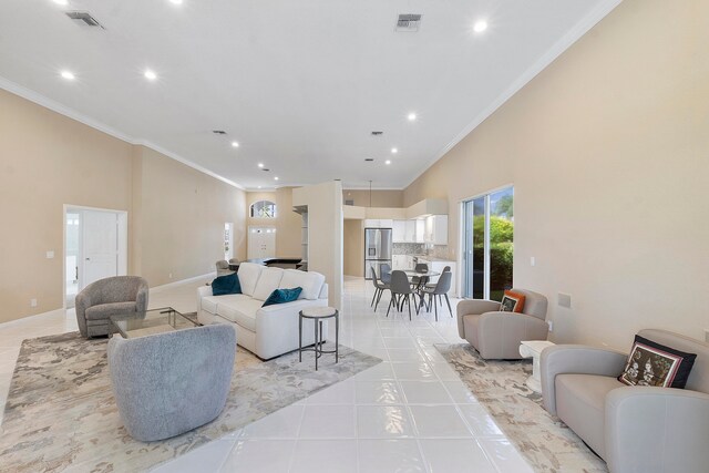 living room with light tile patterned floors, ornamental molding, and high vaulted ceiling