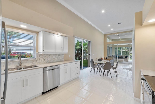 kitchen featuring stainless steel appliances, plenty of natural light, sink, and white cabinetry